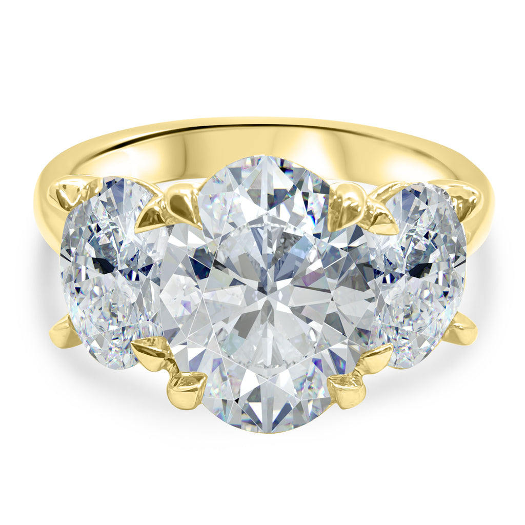 Front view of a 4 carat oval three-stone diamond engagement ring, IGI certified F/VS2, in 14k yellow gold.