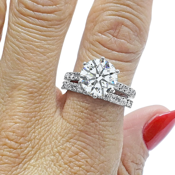 3 carat Art Deco cathedral wedding set with IGI certified F color VS1 diamonds, featuring an engagement ring and bridal band, shown on a hand in 14k white gold.